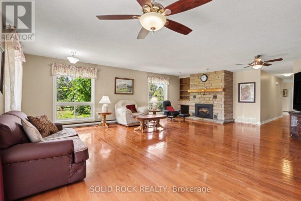 Small wooden dog house in a grassy backyard with trees. - 220 Highfield Crescent, Beckwith