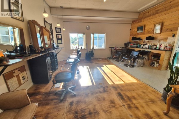 View of a hair salon with styling stations, chairs, mirrors, and shelves stocked with products. - 220 Main Street, Bengough