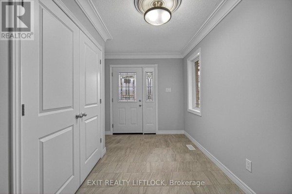 Interior entryway with light gray walls, tiled floor, and a closet. - 220 O'neil Street, Peterborough