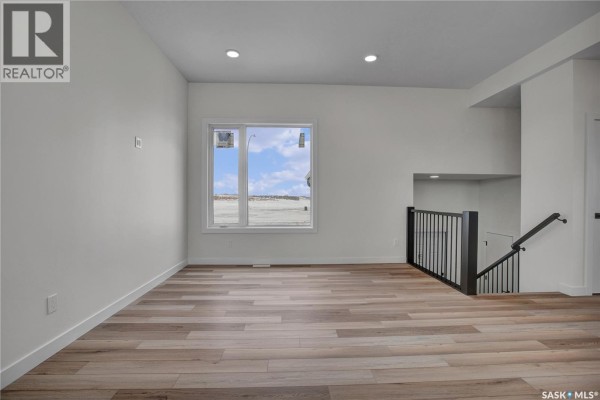 Bright kitchen with an island, pendant lighting, and access to a deck - 220 Veterans Drive, Warman
