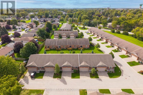 Aerial view showing multiple townhouse buildings with garages arranged in a cul-de-sac. - 220 Walnut Street, Lucan Biddulph