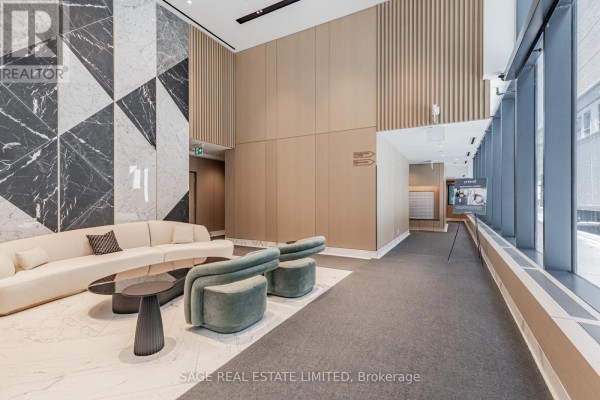 Modern lobby with marble floors, curved sofa, and accent chairs. - 2201 - 38 Widmer Street, Toronto