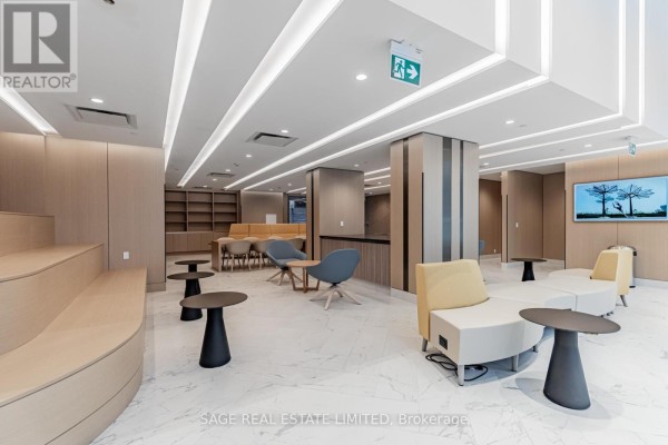 Amenity space with tiered seating, lounge chairs, and television. - 2201 - 38 Widmer Street, Toronto