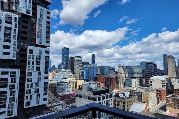 City skyline view from balcony with modern buildings. - 2201 - 38 Widmer Street, Toronto