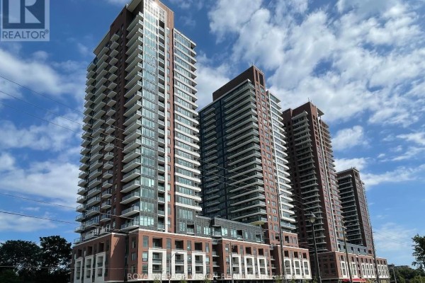 Exterior view of a tall, modern apartment building with balconies and glass windows. - 2201 - 4010 Eglinton Avenue W, Toronto