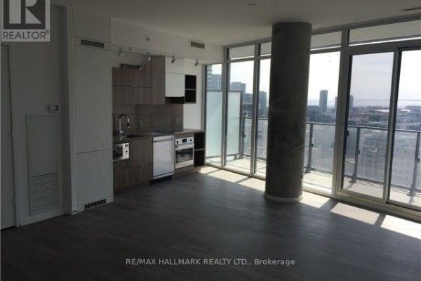 Open-concept living space with kitchen, large windows, and city view. - 2202 - 125 Peter Street, Toronto