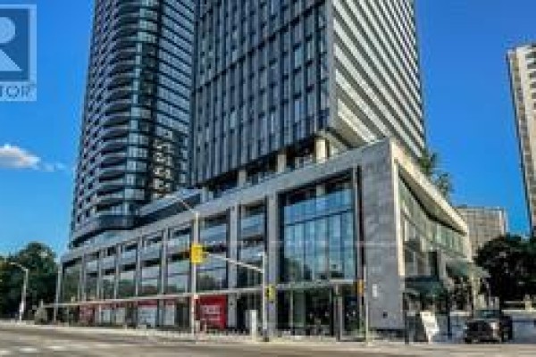 Close-up of the building's entrance with large windows and modern design - 2205 - 575 Bloor Street E, Toronto
