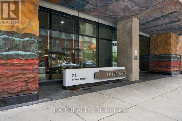 Building entrance with the address 21 Widmer Street and "CINEMA TOWER" sign. - 2206 - 21 Widmer Street, Toronto