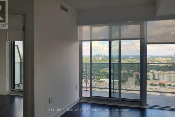 Living room with large windows and a balcony overlooking the city. - 2206 - 50 O'neill Road, Toronto