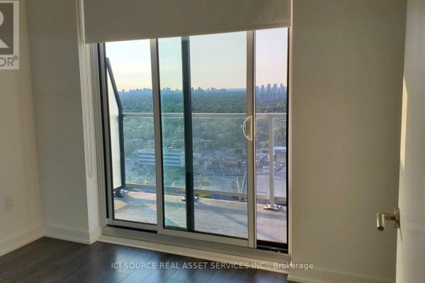 Balcony sliding doors with a view of the city skyline. - 2206 - 50 O'neill Road, Toronto