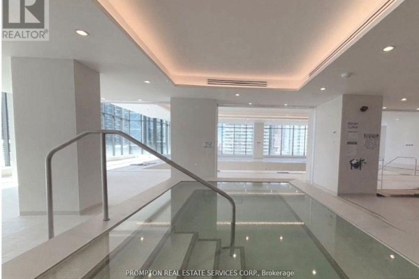 Indoor swimming pool with glass walls, tiered steps, and modern lighting. - 2207 - 1 Concord Cityplace Way, Toronto