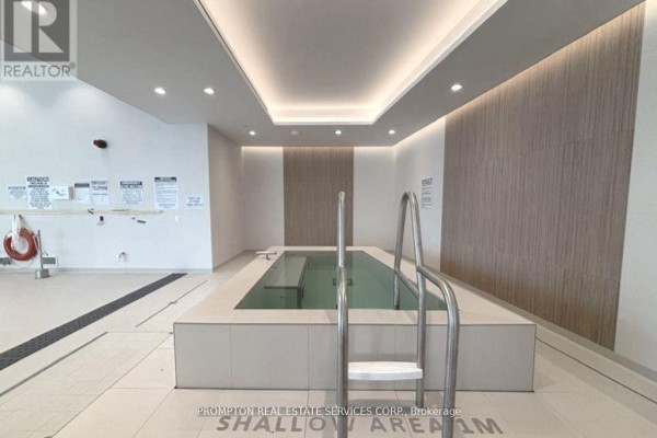 Indoor plunge pool with tiered steps, stainless steel handrails, and tiled floor. - 2207 - 1 Concord Cityplace Way, Toronto