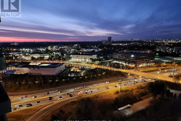 Sunset view over a highway and city from a high-rise apartment. - 2207 - 181 Wynford Drive, Toronto