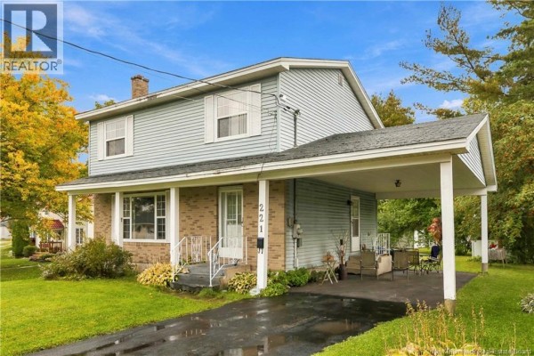 Side view of the house at 221 Broadway Street, Moncton, showing the carport and front entrance. - 221 Broadway Street, Moncton