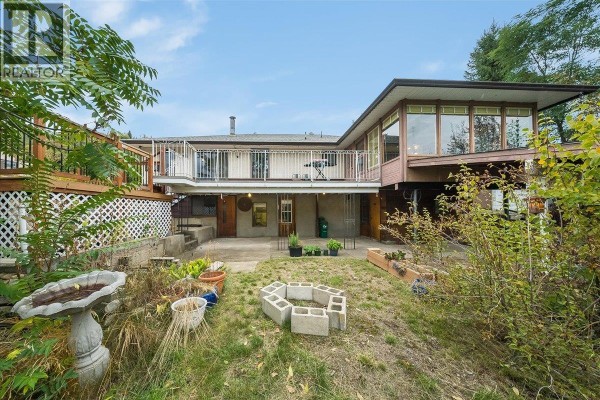 Rear exterior view of a house with a deck, patio, garden beds, and a fire pit area. - 221 Second Avenue, Rivervale