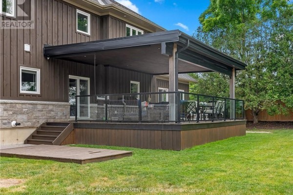 Covered deck with glass railings and outdoor furniture - 2210 Highway 54 Haldimand