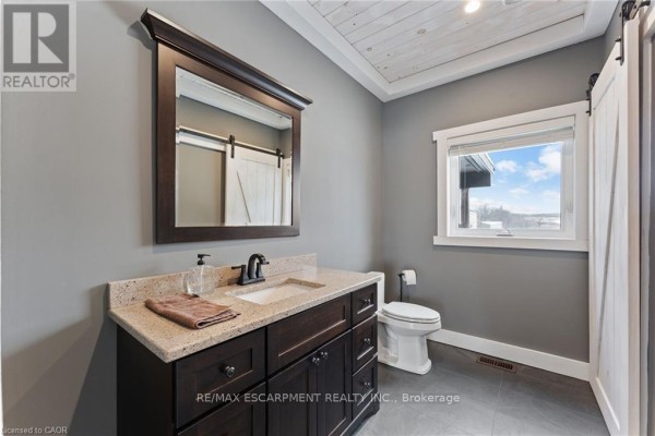 Bathroom with vanity, granite countertop, and barn door - 2210 Highway 54 Haldimand