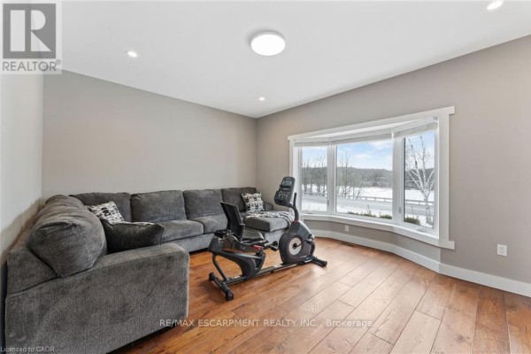 Living room with sectional sofa, exercise bike, and bay window - 2210 Highway 54 Haldimand