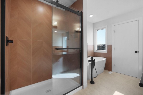 Contemporary bathroom with a freestanding tub, glass shower enclosure, and tile accent walls. - 22108 94 Av Nw, Edmonton
