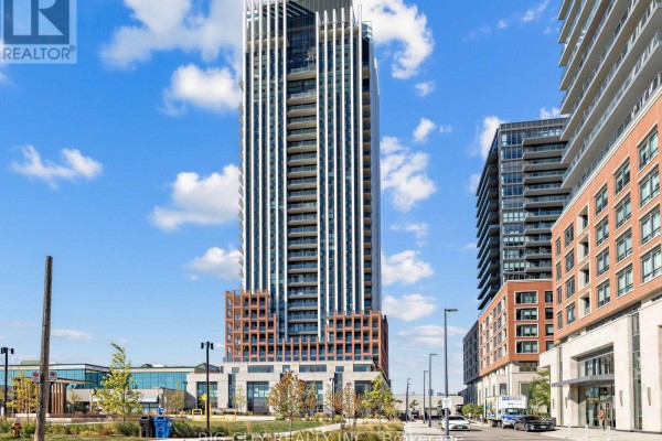 Exterior view of a tall condominium building with balconies and surrounding cityscape. - 2211 - 25 Frederick Todd Way, Toronto