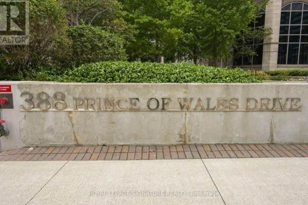 Close-up of a concrete wall with "388 Prince Of Wales Drive" metal lettering and landscaping. - 2211 - 388 Prince Of Wales Drive, Mississauga