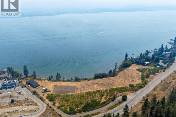 Expansive aerial view of the lakefront property and surrounding residential development. - 2211 Campbell Road, West Kelowna