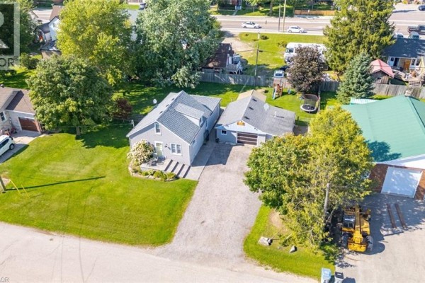Aerial view of the residential property with a grey house, garage, and surrounding trees. - 2214 William Shakespeare Street, Shakespeare