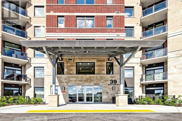 Entrance canopy with modern metal supports and stone-clad pillars. - 222 - 39 New Delhi Drive N, Markham