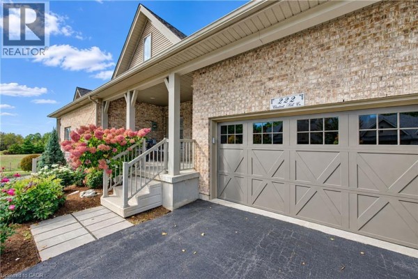 Close-up exterior view of a townhouse garage and covered front porch. - 222 Chestnut Hill Crescent, Kitchener