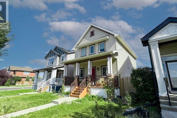 Street view of a row of houses with similar architectural styles and siding. - 222 Copperpond Boulevard Se, Calgary