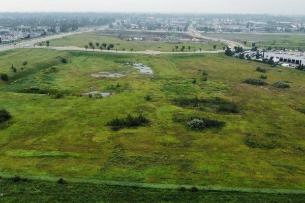 Aerial view of undeveloped green land with scattered trees and small ponds on the property. - 2220 Broadmoor Bv, Sherwood Park
