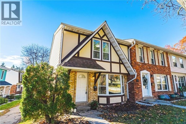 Spacious living room with sectional sofa, large TV, and hardwood flooring, with access to the foyer. - 2220 Upper Middle Road Unit# 4, Burlington
