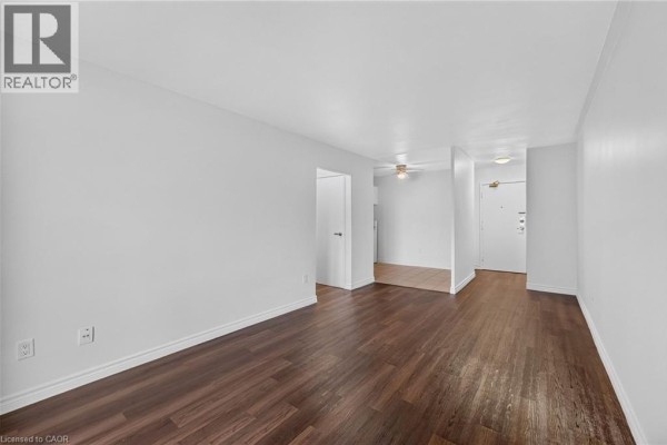 View of the living area from the hallway, showing access to a kitchen. - 223 Jackson Street W Unit# 908, Hamilton