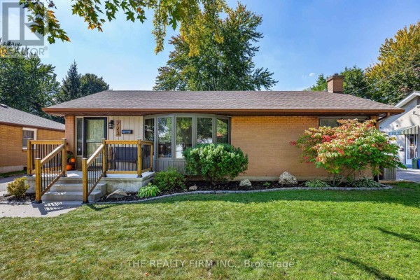 Front view of a brick bungalow with a well-maintained lawn and landscaping. - 223 Michaelmas Street, London East
