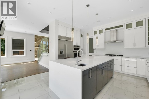 Modern bathroom with a white vanity, square sink, and glass-enclosed shower. - 2237 Windsail Place, Squamish
