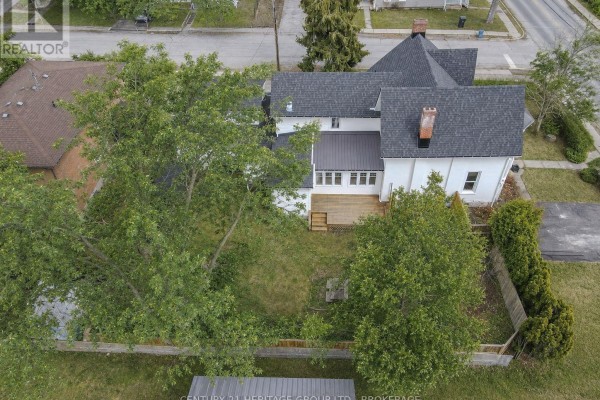 Exterior of house with deck and mature trees - 2238 Little Long Lake Road Frontenac
