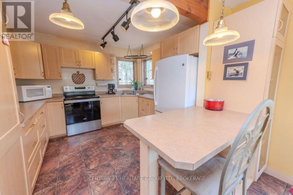 Kitchen with light wood cabinets, stainless steel oven, and breakfast nook - 2238 Little Long Lake Road Frontenac