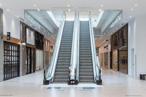 Two escalators on the ground floor of a mall, leading to upper levels. - 224 - 7777 Weston Road, Vaughan