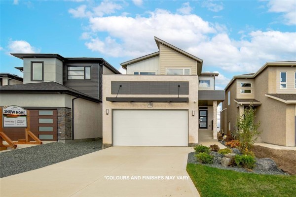 Front exterior of a modern two-story house with a large garage door and entrance. - 224 Blossom Way, West St Paul