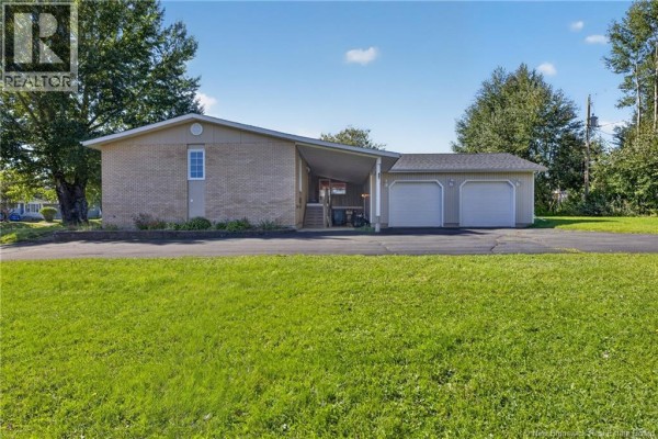 Exterior of bungalow with attached two-car garage and covered carport. - 224 Francine, Beresford