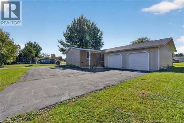 Asphalt driveway leading to attached two-car garage and side of house. - 224 Francine, Beresford