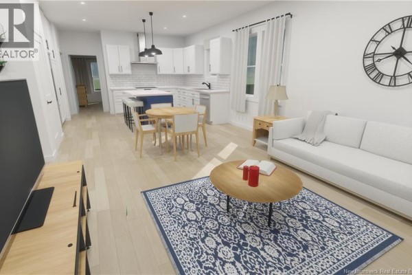 Living room with a white sofa, coffee table, and a dining area adjacent to an open kitchen. - 224 Mowat Drive Unit# 6, Saint Andrews