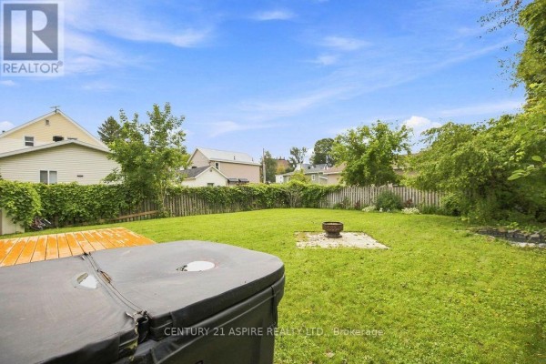 Backyard with hot tub cover, deck, and fire pit - 224 Nelson Street Pembroke