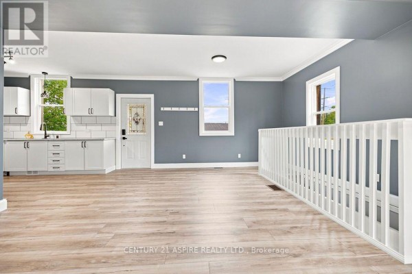 Modern kitchen with white cabinets and wood-look flooring - 224 Nelson Street Pembroke