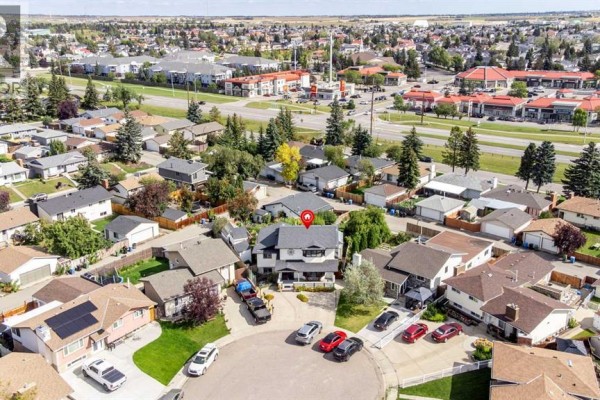 Aerial view of 224 Pinetree Bay Ne, Calgary, showing the house on a cul-de-sac lot. - 224 Pinetree Bay Ne, Calgary