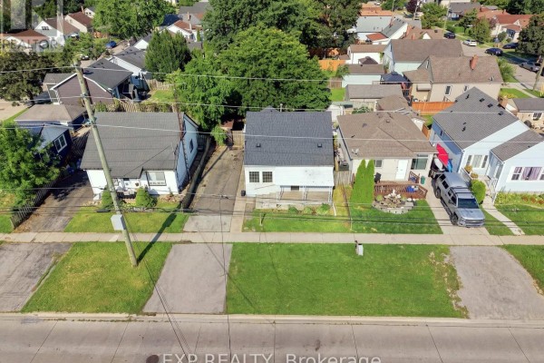 Aerial view of the residential street showing multiple houses, driveways, and backyards. - 225 Grantham Avenue, St  Catharines