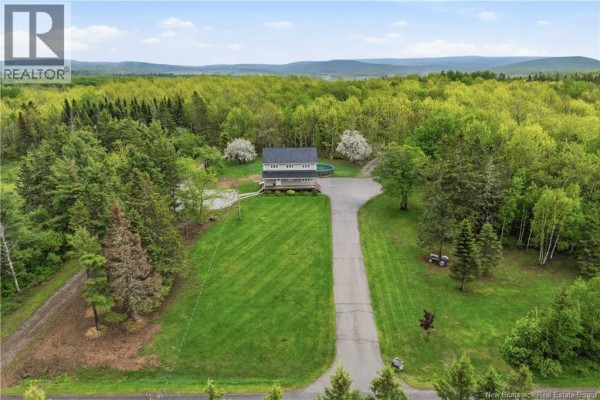 Aerial view of a house surrounded by trees and a large grassy lawn. - 225 Quirk Road, Wards Creek