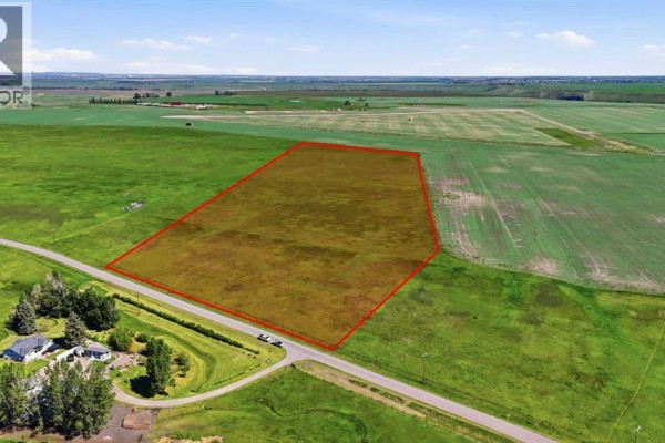 Aerial property map showing a large lot outlined in white, located off 253 DR E, with surrounding fields and roads. - 2253 Drive, Rural Foothills County