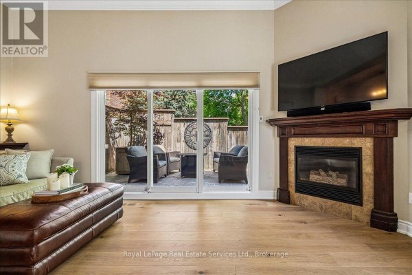 Dining room with wood table, chairs, tile flooring, and patio door. - 2254 Marine Drive, Oakville