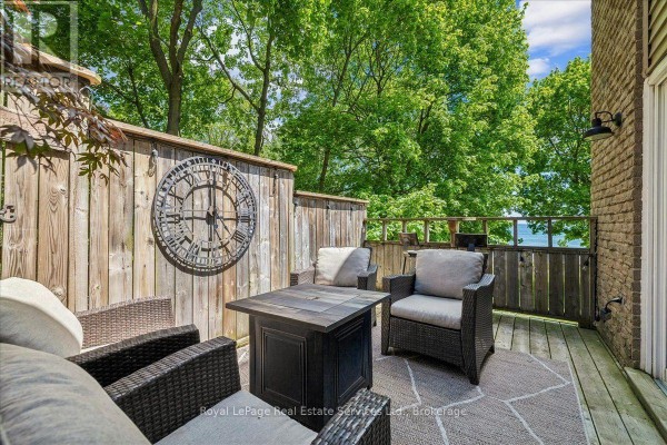 Kitchen with cream-colored cabinets, granite countertops, and stainless steel appliances. - 2254 Marine Drive, Oakville